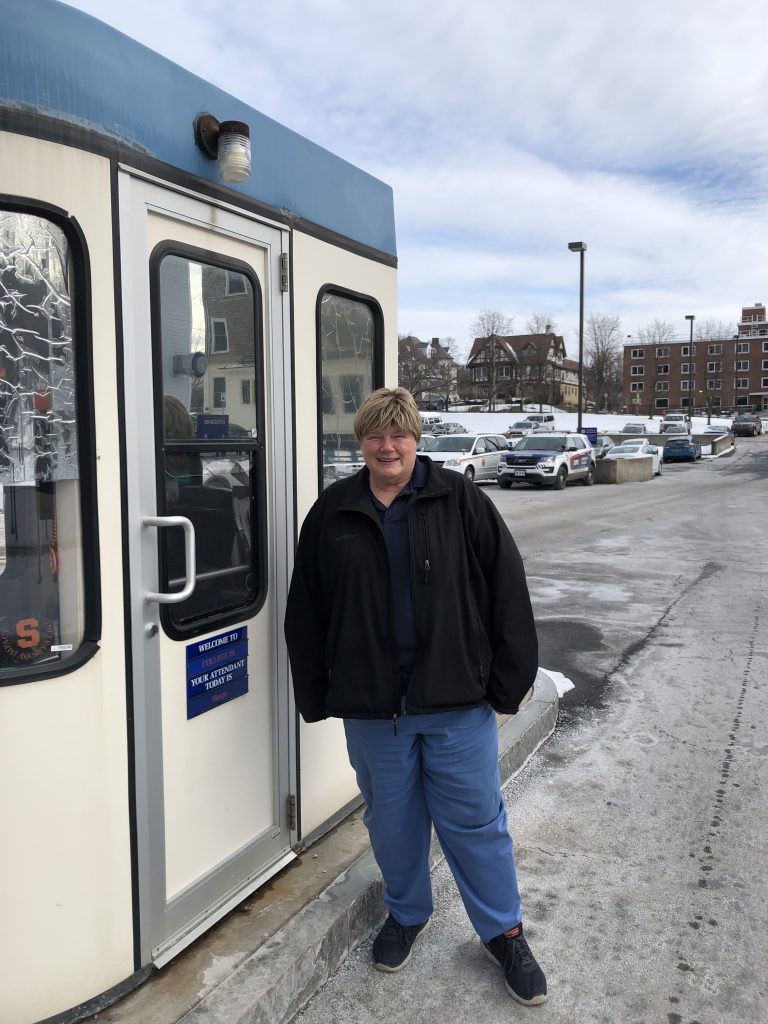 Woman Standing Outside of Parking Booth