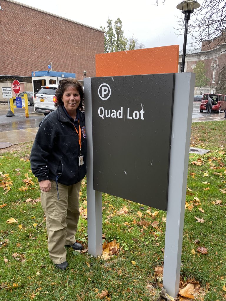 Woman Standing Next To Quad Lot Sign