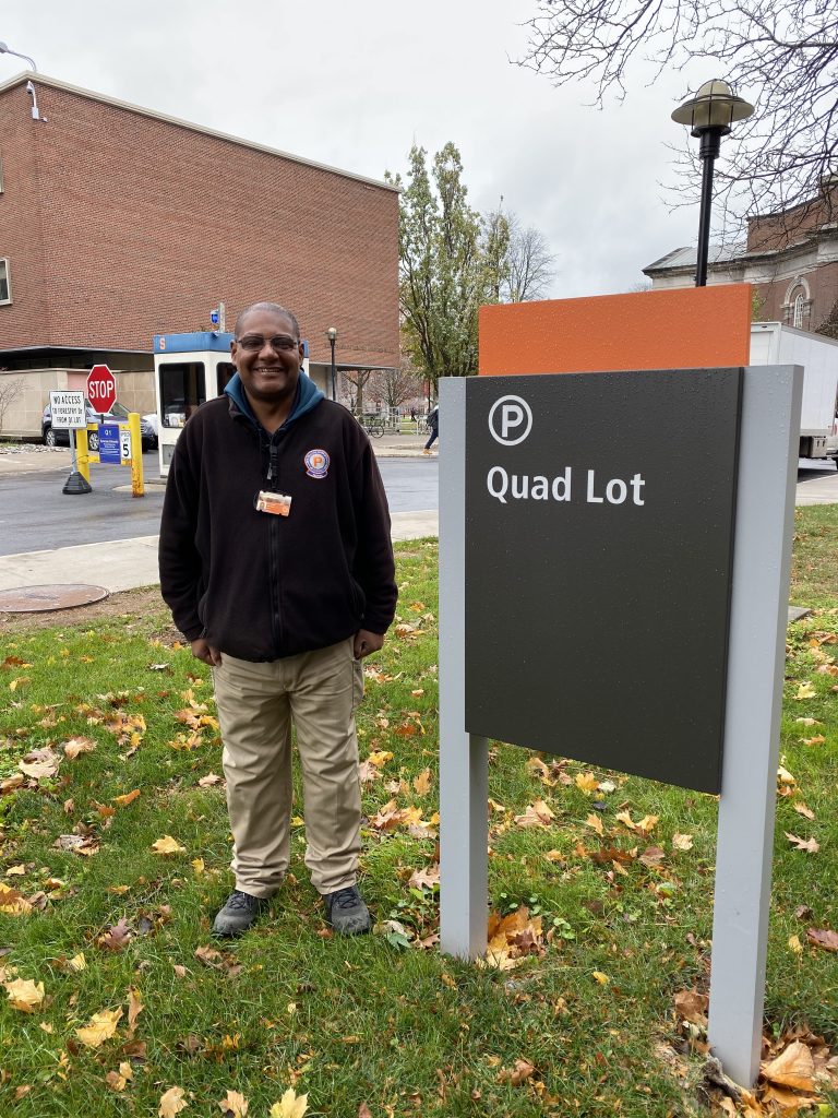 Man Standing Next To Quad Lot Sign